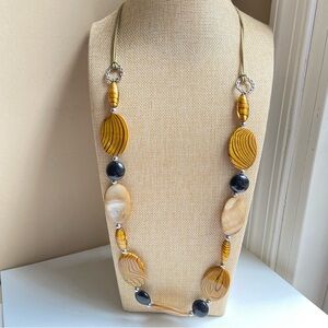 Long glass and dyed shell beaded necklace in tan, striped golden brown and black